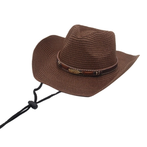 Elegant wide brim brown woven straw cowboy hat with golden feather band and chin strap
