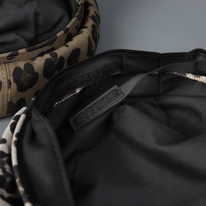 Detail showing inner black lining and adjustable velcro strap of the leopard print cap