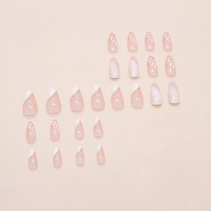 French tip almond fake nails with hand-painted leaves and fine golden glitter lines