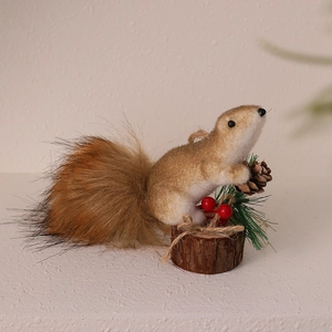 Detailed shot of foam squirrel ornament with pine cones and berries for Christmas decor