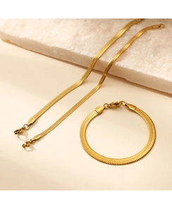 Detailed view of gold stainless steel flat snake chain necklace and bracelet set