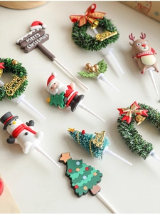 Detailed collection of festive Christmas cake toppers featuring Santa, snowman and elk
