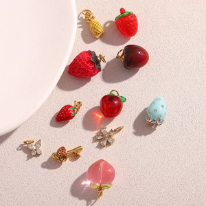 Collection détaillée de breloques dorées 18K en forme de fraise, papillon et de fleur