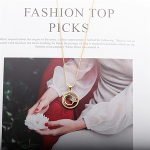 Detailed view of gold moon and star pendant necklace on a fashion magazine background