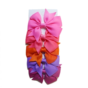 Set of five ribbed ribbon fishtail bow hair clips in assorted pink and purple shades