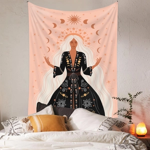 Detail of bohemian tapestry featuring sun and moon illustration on a bedroom wall