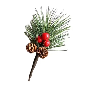 Detail of Christmas pine needle branch with red berries and natural pinecones for DIY decor