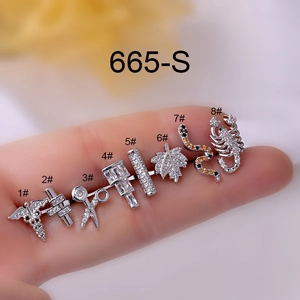 Macro shot of 8 assorted titanium steel stud earrings including snake and scorpion designs