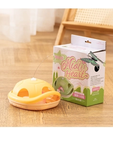 Electric butterfly cat toy turtle base and packaging on a warm wooden floor detail
