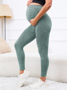 Detail of high-waisted seamless maternity leggings showing abdominal support and mesh texture