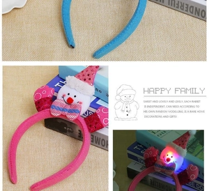 Detail of LED glowing snowman headband with sequins and plush fabric for Christmas