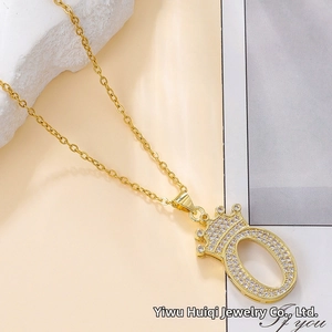 Detailed view of gold crown letter O pendant necklace with sparkling pavé cubic zirconia