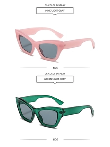 Detail view of pink and green cat-eye sunglasses with light gray lenses from a side angle