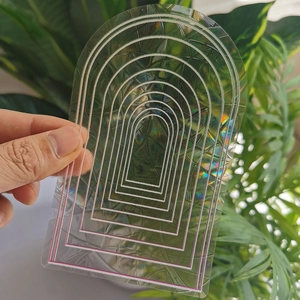 Close-up of rainbow suncatcher static sticker with arch design and iridescent prism effect