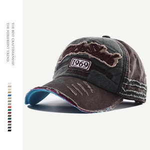 Macro shot of vintage washed canvas baseball cap with 1969 embroidery and distressed holes