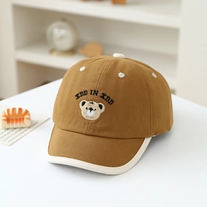 Detail of cute bear embroidery and contrast piping on the brown cotton baseball cap