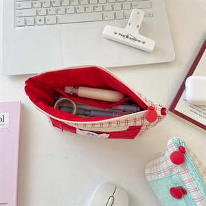 Macro shot of red checkered pencil case with red lining and interior stationery storage