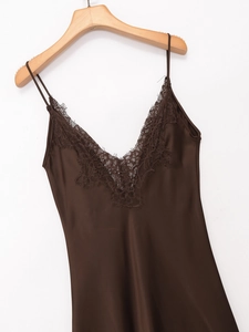 Detailed view of deep brown satin slip dress with elegant lace trim at V-neckline
