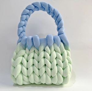 Detail of chunky mint green and light blue handmade knit bag with thick yarn texture