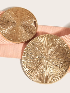 Detailed close-up of light pink elastic belt featuring twin gold sunburst metal buckles