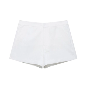 Flat lay close-up of white summer shorts with button detail and smooth cotton fabric