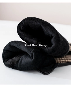 Close-up detail of soft black short plush lining inside warm plaid winter gloves