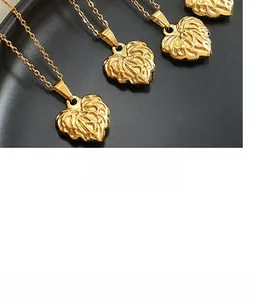 Detailed macro view of gold heart pendant with radial pleated texture on a fine chain
