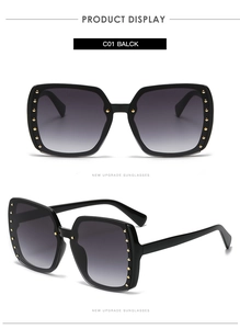 Detail of square oversized sunglasses with black frame and golden rivet decorations