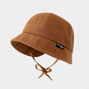 Detailed texture of cotton bucket hat with adjustable chin strap and soft wide brim