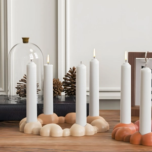 Detail of bubble stone candle holder with white pillar candles in a cozy home setting