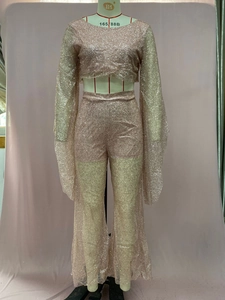 Detail of pink sequin two-piece set featuring long sleeve crop top and high-waist pants