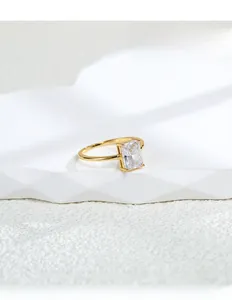 Macro detail of emerald cut square zircon ring with four-prong gold setting