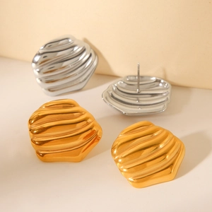 Textured 18K gold and silver titanium steel earrings with a unique rock-like wavy finish