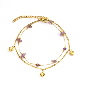 Detail of double-layered gold heart anklet featuring natural purple stones and charms