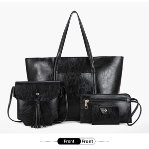 Front view of black four-piece set including tote bag, crossbody bag, wallet, and card holder