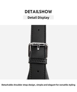 Detail of adjustable black leather shoulder strap with silver metal buckle on a handbag