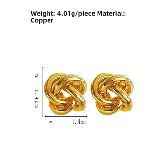 Macro detail of gold knot earrings showing hollow rope texture and dimensions