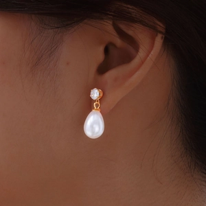 Elegant stainless steel pearl earrings with clear zircon stones on a gold-plated setting
