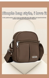 Detailed view of dark brown nylon crossbody bag with multi-zipper pockets and jacquard strap