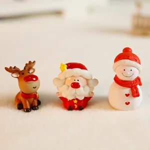Miniature resin Christmas figurines set including Santa, reindeer, and snowman decor