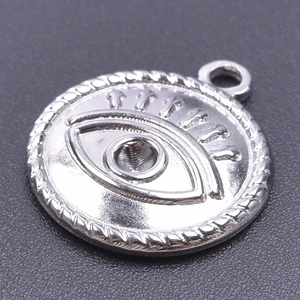 Detail of silver Masonic All-Seeing Eye pendant with embossed relief on black texture
