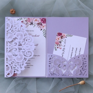 Macro detail of laser-cut wedding invitation set with purple lace and floral RSVP card