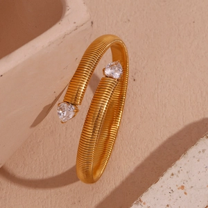 Macro shot of 18K gold plated striped cuff with heart-shaped zircon stones