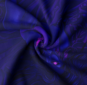 Detail of silky tapestry fabric showing mystical portrait art and smooth texture