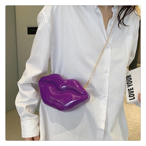 Detailed view of creative purple lip-shaped crossbody bag with elegant gold metal chain
