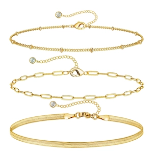 Detailed view of 3-piece gold chain set with beaded, paperclip, and snake chain textures