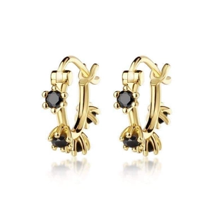 Elegant gold hoop earrings with black faceted zircon stones on a white reflective base