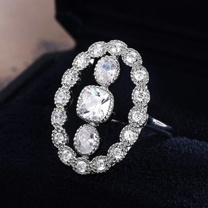 Luxury oval hollow engagement ring with sparkling cubic zirconia set on black velvet