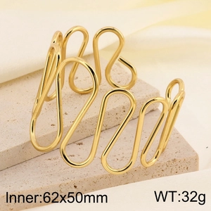 Detail of irregular curved golden cuff bracelet with inner 62x50mm size dimensions