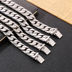 Polished silver titanium steel Cuban link bracelets for men on a professional dark background